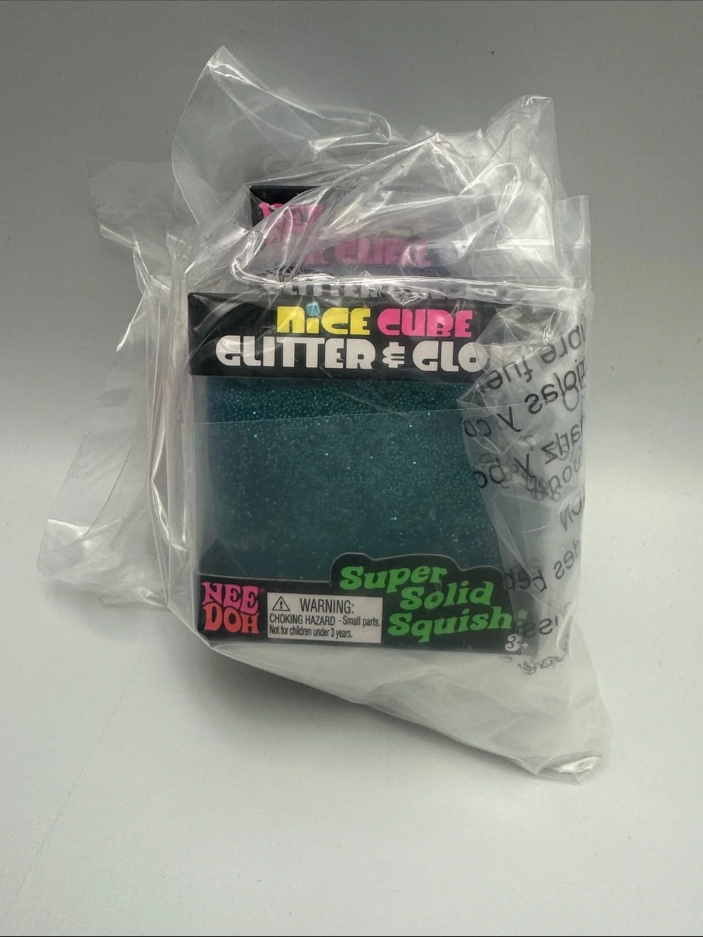 Icee Cube Glitter & Glow Super Solid Squish - needoh with plastic protection